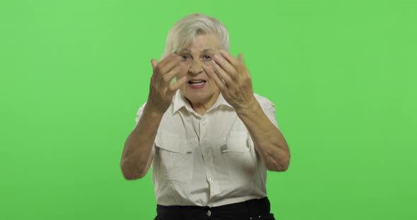 An Elderly Woman Shout and Waving with Hands. Old Grandmother Smiles. Chroma Key alt