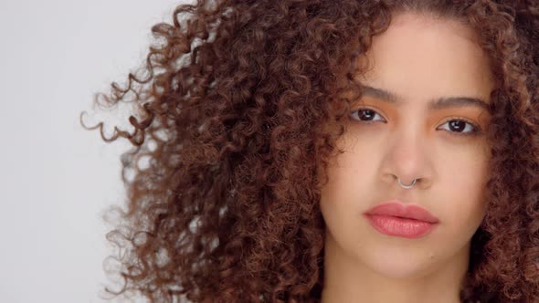 Mixed Race Black Woman with Freckles and Curly Hair in Studio on White Poses To a Camera