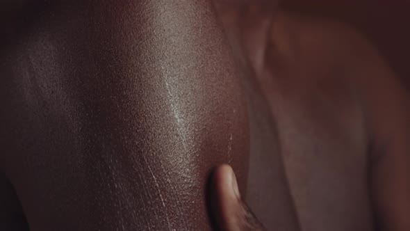 Black Man Using Body Cream alt