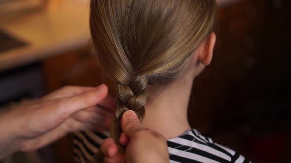 Caring Mother Making Braid with Weave Hairstyle with Hands Daughter Child Long Hair Girl Wearing