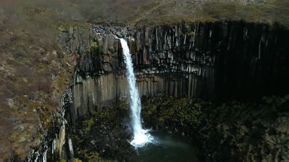 Aerial View of the Svartifoss Waterfall Surrounded By Basalt Columns in Iceland alt