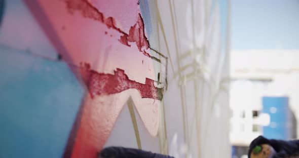 Graffiti artist touching the painted wall 4k alt