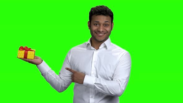 Man Holding Gift Box and Pointing on It alt