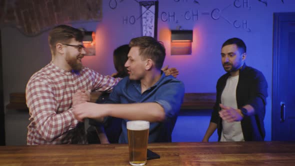 Friends Meet in Pub at Bar Counter