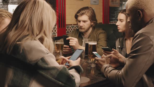 Bored Friends Using Smartphones During Dinner alt