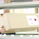 Worker Puts a Carton with Goods From Japan on the Shelf - VideoHive Item for Sale