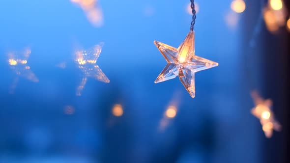 Star garland.Christmas and New Years time. Shining star on blue background alt