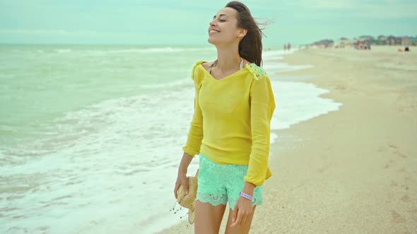 Portrait Happy Expression Woman with Blowing Hair Wearing Yellow Shirt Having Fun on Beach and alt