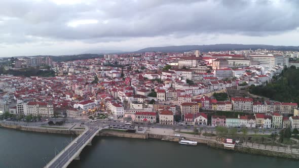 Aerial drone view of Coimbra city and Mondego river at sunset alt