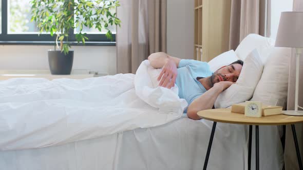 Man Sleeping in Bed at Home alt