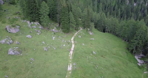 Aerial drone view of hikers hiking in the mountains. alt