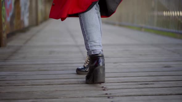 Townswoman Is Walking Alone on Wooden Bridge in Autumn Day, Closeup of Feet alt