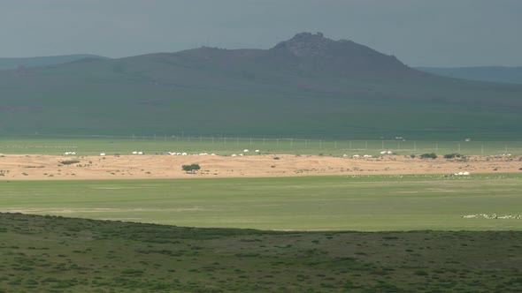 Desert Sand Dunes and Ger Yurts in Mongolian Meadows alt