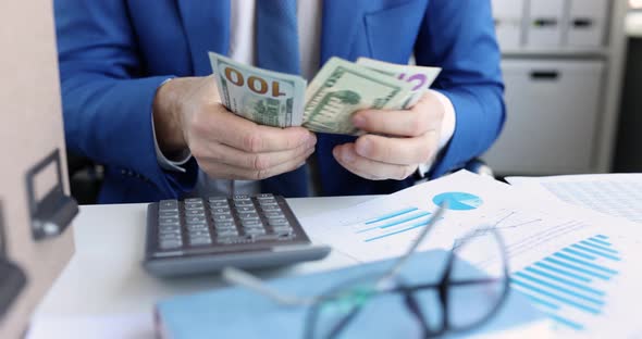 Businessman Examines Financial Report Counts Cash and Adds Up on Calculator  Movie alt