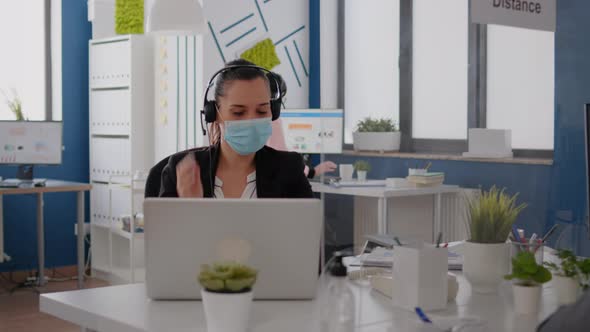 Executive Manager Wearing Protective Face Mask and Headphone alt