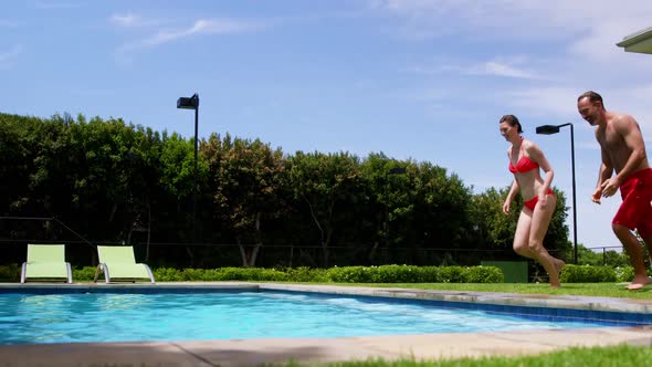 Family enjoying in swimming pool alt