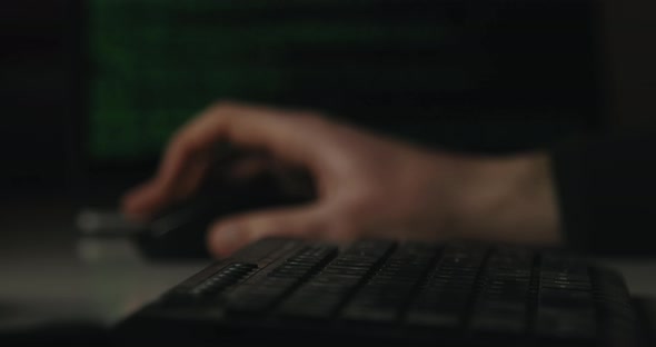 Hacker is Typing Keys on a Keyboard in His Room alt