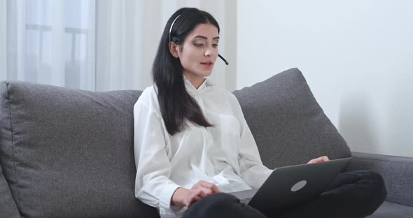 Female Freelancer Sitting on the Couch and Working on a Laptop Video Call Female Work in Technical alt