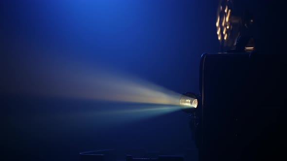 Vintage Movie Projector Projecting Film in a Dark Room