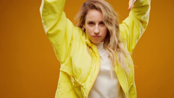 Woman Professional Dancer Dancing in Studio Against Yellow Background alt