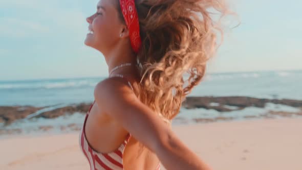 Young Caucasian Woman Teen in Bathing Suit Runs Along Beach Holding Hand Person alt