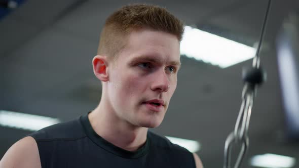 Closeup Portrait of Concentrated Handsome Sportsman Training in Gym alt