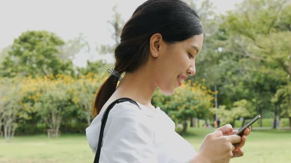 Beautiful Asian young woman shot surfing the net online.