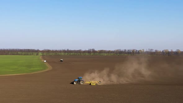 The Stubble-Tillage Cultivation After Harvest With Big Blue Modern Tractor Aggregated With Equipment