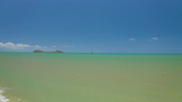 Aerial, Beautiful View On The Ocean And A Large Tropical Beach In Cairns, Queensland In Australia