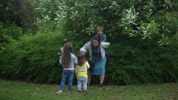 Happy Family Mother Two Three Little Siblings Kids Playing Running Hug Kiss Mom Enjoying Summer alt