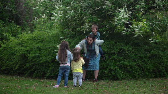 Happy Family Mother Two Three Little Siblings Kids Playing Running Hug Kiss Mom Enjoying Summer