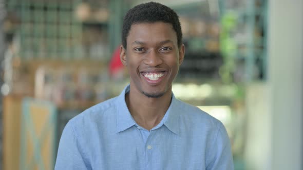 Positive Young African Man Doing Thumbs Up alt