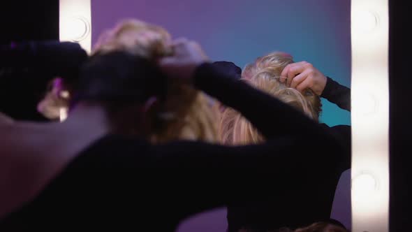 Good-Looking Travesty Diva Putting on Blond Wig, Preparing for Transgender Party alt