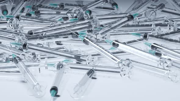 Animation with a pile of used empty clear plastic disposable syringes. 4K