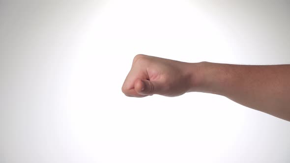 A Man's Hand Shows Dislike Thumb Down on a White Background