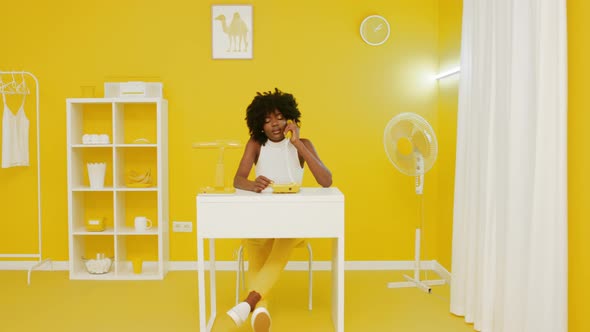 Serious Woman Has Phone Talk In Art Office alt