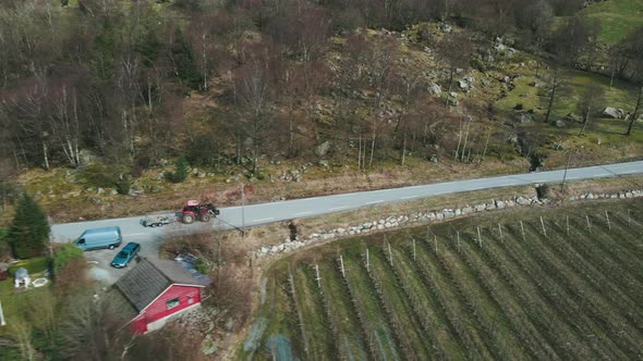 Farm Truck Transporting Flock Of Sheep To Pasture On A Sunny Day. aerial tracking alt