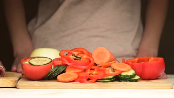 The woman exchanges fresh vegetables for raw meat alt