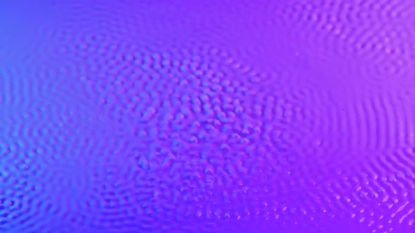 Strong Vibration Lifts Drops Milk with Pink Blue Tint Upward alt