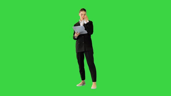 Young Woman in Office Suit is Getting Ready to Perform Looking Into Document on a Green Screen