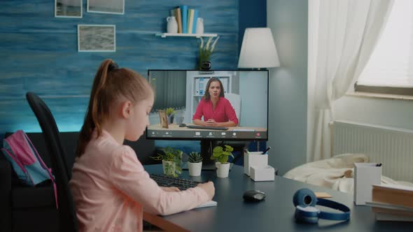 Schoolgirl and Teacher Using Video Call for Remote Lessons alt