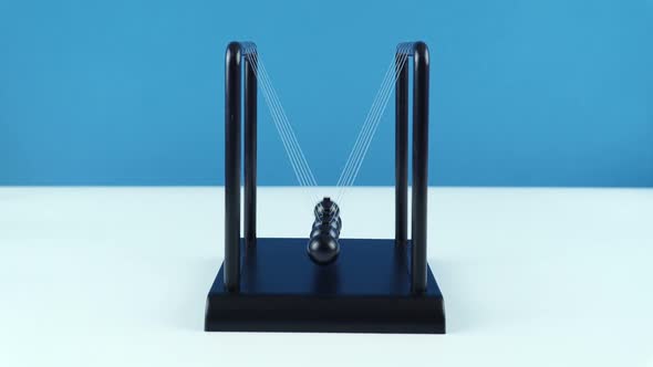 Desktop Pendulum Small Newton Balls On A Blue Background.