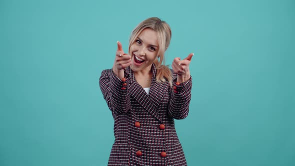 Mature Blonde with Beautiful Smile Looks with Finger in Front Smiling with Teeth alt