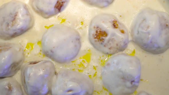 Close-up of Cooking Delicious Meatballs in a Cream Sauce