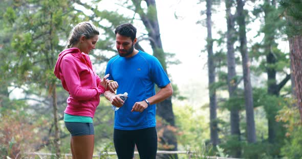 Couple checking a time in forest alt
