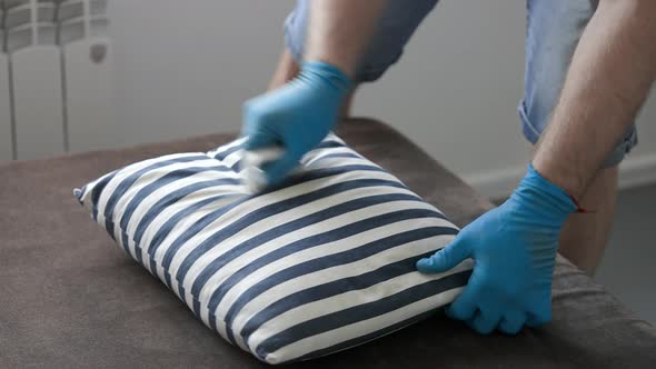 Professional Cleaner Cleaning the Sofa and Pillows alt