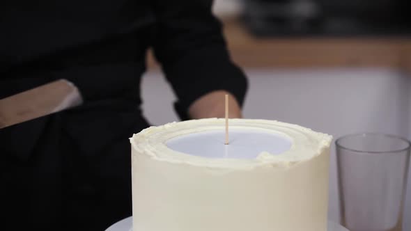 The Pastry Chef's Hands Level the Cream Cake