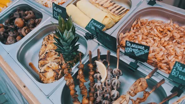 Various Street Food Is Sale on Display Case at Festival. Street Market on Party alt