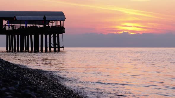 Panorama of the Sunset Over the Sea Next To the Silhouette of the Pier. alt