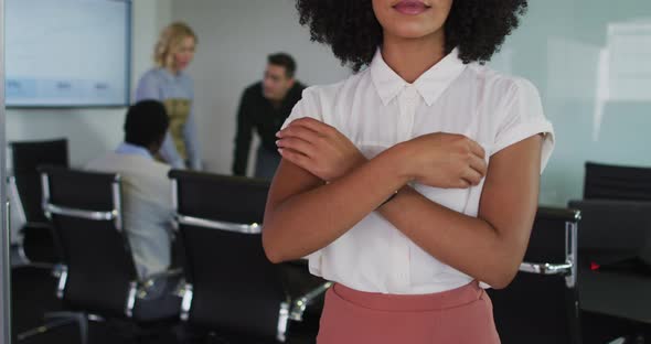 Portrait of african american businesswoman in a meeting room looking to camera smiling alt